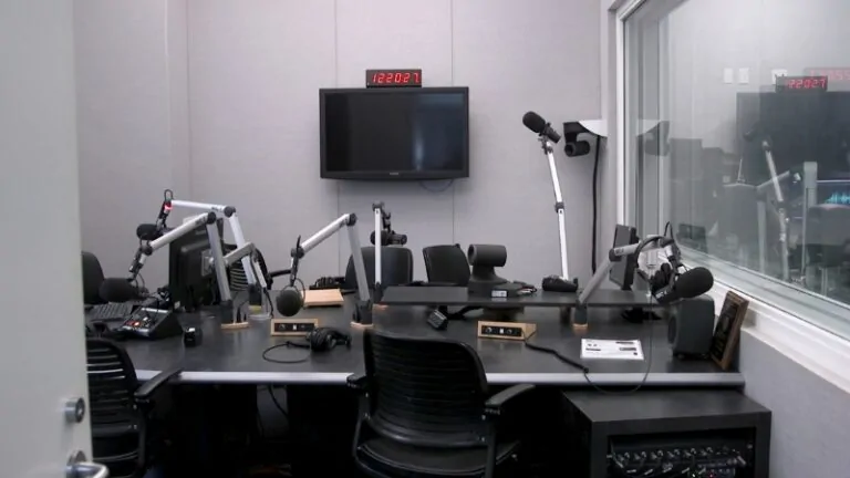 A modern campus radio studio with microphones and recording equipment representing the best colleges for journalism