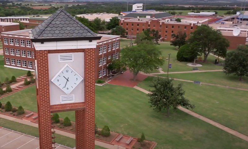 Aerial view of Langston University's clock tower in front of a prominent building