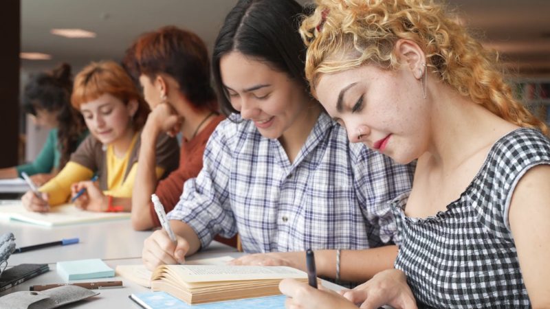 US students studying together abroad and taking notes in a classroom setting
